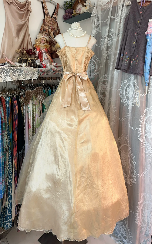 A gold, backless, fitted long dress with a multi-layered, voluminous skirt; a ball gown R6298