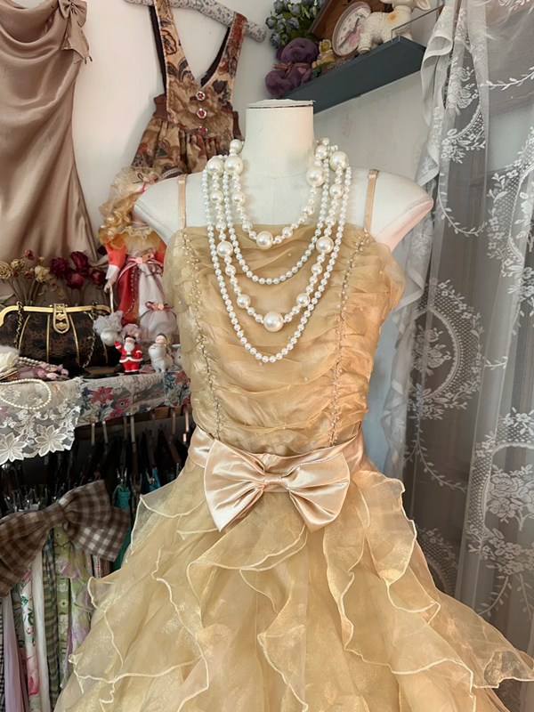 A gold, backless, fitted long dress with a multi-layered, voluminous skirt; a ball gown R6298