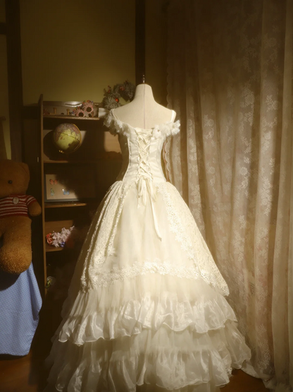 White off-the-shoulder floor-length ball gown with a cinched waist, slim fit and voluminous puffy skirt; bridal gown R7293
