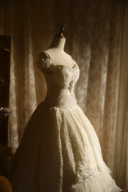 White off-the-shoulder floor-length ball gown with a cinched waist, slim fit and voluminous puffy skirt; bridal gown R7293