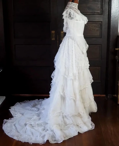 White lace square-neck long-sleeve ball gown with a cinched waist, vintage style and tiered cake skirt; bridal gown R7295