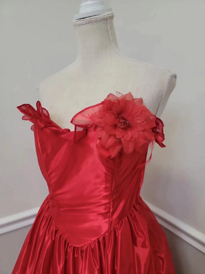 Red strapless ball gown with a cinched waist and an asymmetrical skirt; bridal gown R7297