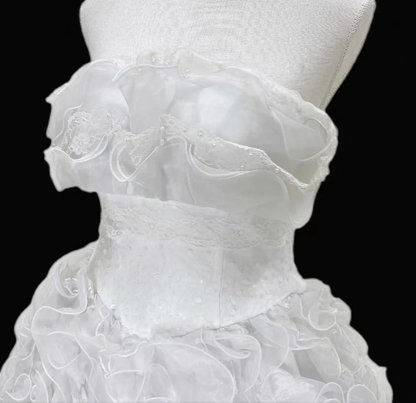 White strapless ball gown with a cinched waist and a voluminous tiered cake skirt; bridal gown R7300