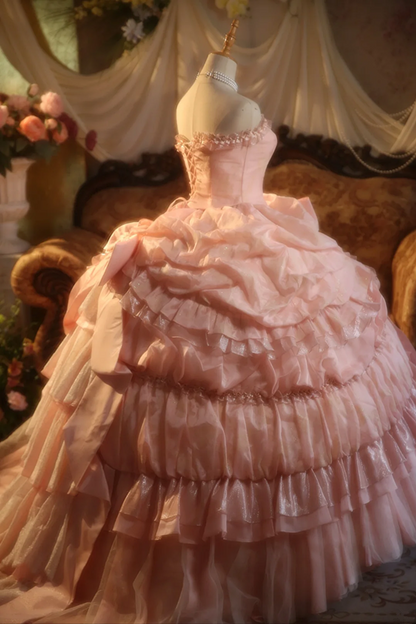 Pink strapless ball gown with a cinched waist and a voluminous tiered cake skirt; bridal gown R7282
