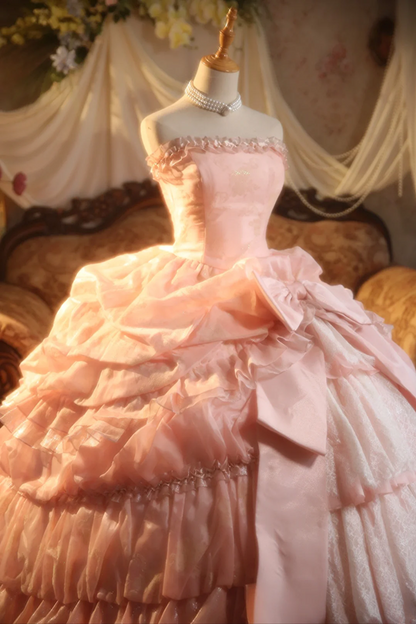 Pink strapless ball gown with a cinched waist and a voluminous tiered cake skirt; bridal gown R7282