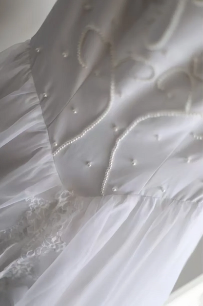White fitted long ball gown with beaded details exudes elegance R6690