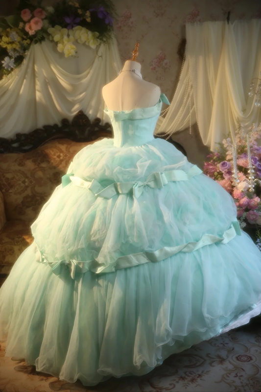 Light green strapless ball gown with a cinched waist and a voluminous puffy skirt; bridal gown R7283