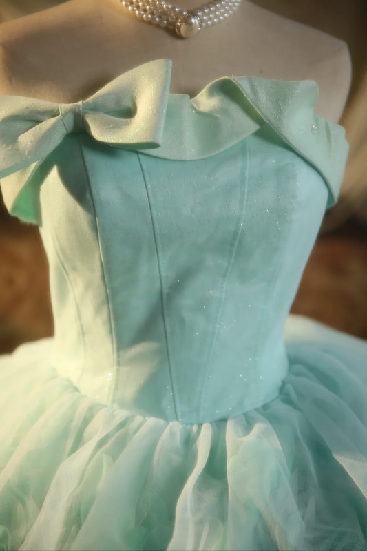 Light green strapless ball gown with a cinched waist and a voluminous puffy skirt; bridal gown R7283